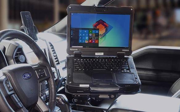 Full NPT Docking Station with Power Adaptor for TOUGHBOOK 40 mounted on top of shifter of car