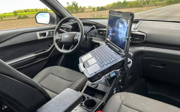Rugged laptop mounted in a vehicle's front cabin.