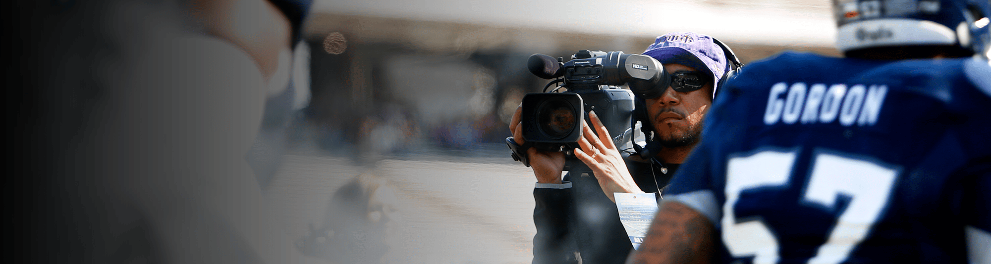 Man with Studio Camera System filming an NFL player walking out