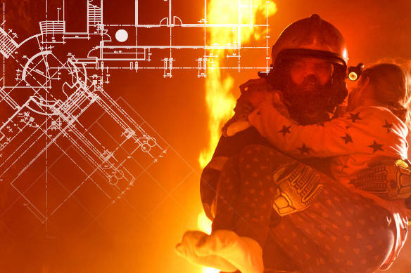 Firefighter carrying woman in his arms while fire blazes in the background