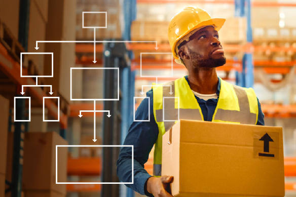 Man with yellow hard hat carrying a box