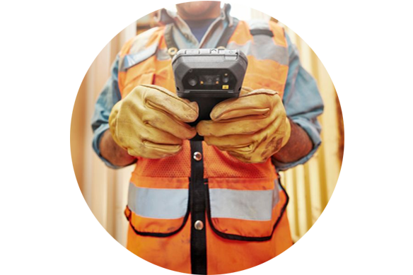 Man with high visibility vest holding a handheld device