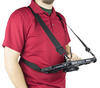 Man wearing a red shirt using a rotating hand strap with a tablet.