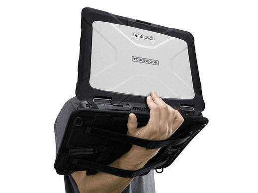 Rugged laptop with a protective case held by a person.
