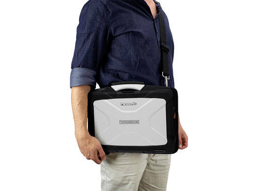 Man holding a portable gray protective case with a handle.